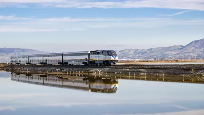 Amtrak train passing over bridge on Alviso Marsh near San Jose, California.